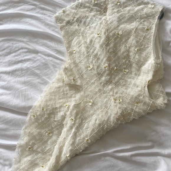 Stunning ivory white open cutting out with delicate flowers cute detailing. - Picture 6 of 16